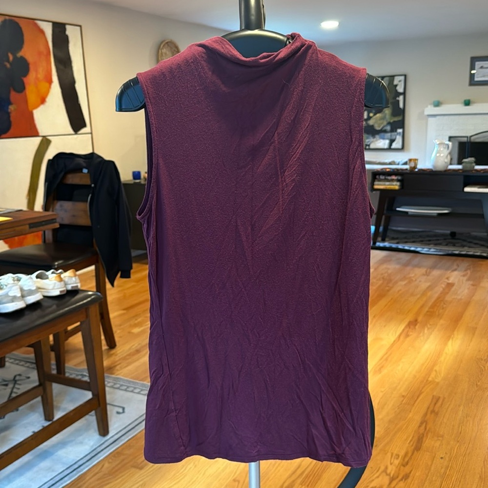 The color is more plum than purple. Tight fitting, body hugging high neck.